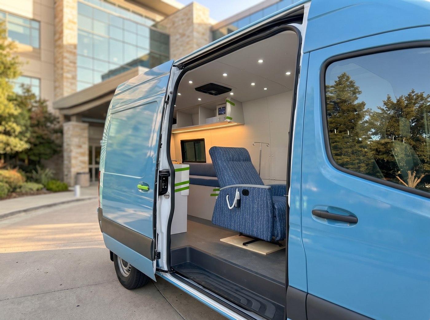 Side door of a QSC mobile infusion van open showing the clinical workspace inside